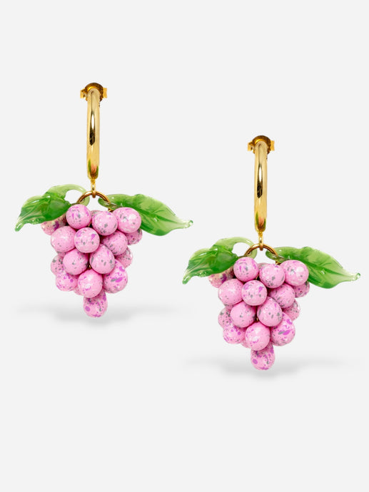 Pink grape earrings with gold hoops.