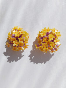 Handmade statement colourful flower beaded earrings with a retro style.