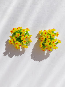 Handmade statement colourful flower beaded earrings with a retro style.