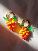 Load image into Gallery viewer, Handmade gold hoop earrings with a glass grape charm.