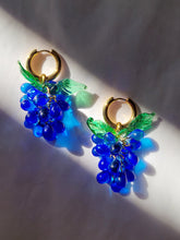 Load image into Gallery viewer, Cute gold plated hoop earrings with a blue handmade glass grape charm. The perfect gift for the woman who loves colorful jewelry.