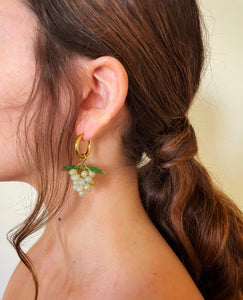 Gold hoop earrings with glass grape charm.